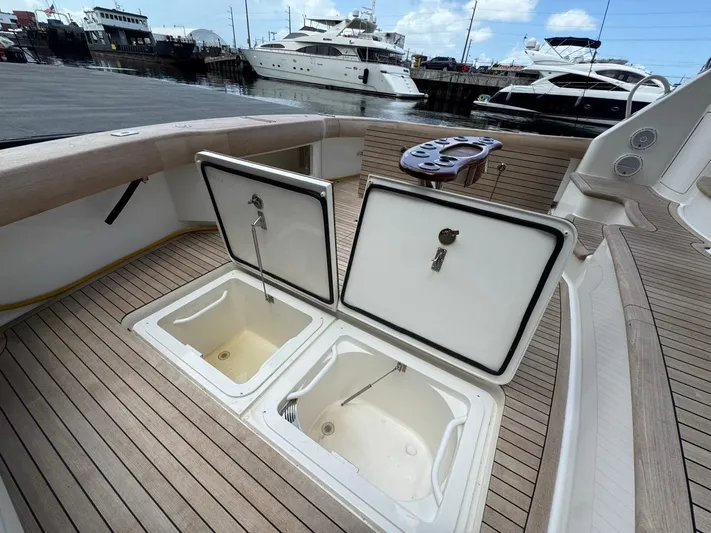 Dry Bones Yacht Photos Pics 2017 Viking 66 Enclosed Bridge yacht deck with open storage compartments at marina.