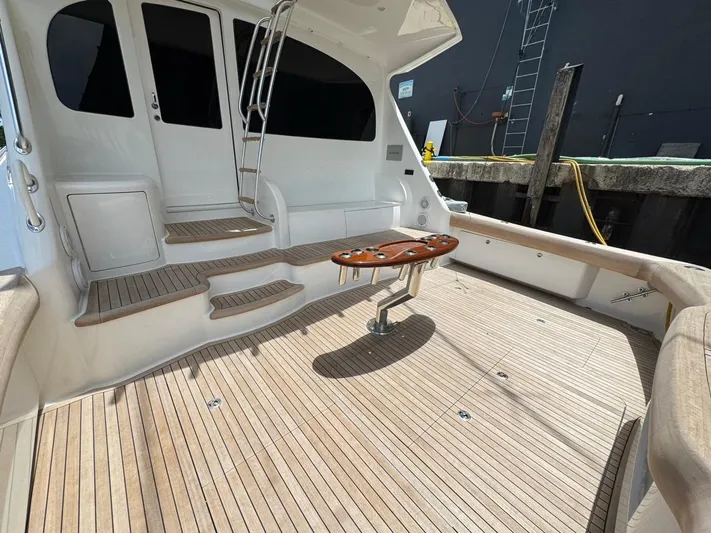 Dry Bones Yacht Photos Pics 2017 Viking 66 Enclosed Bridge yacht deck with teak flooring and ladder.