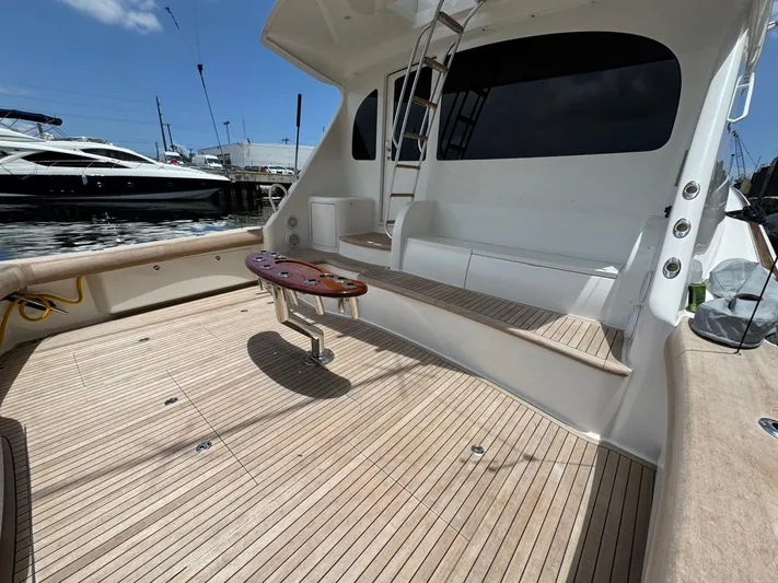 Dry Bones Yacht Photos Pics 2017 Viking 66 Enclosed Bridge yacht deck with seating and ladder, docked at marina.