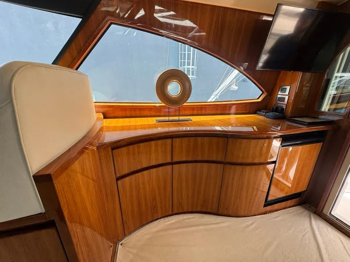 Dry Bones Yacht Photos Pics Luxurious interior of 2017 Viking 66 Enclosed Bridge yacht with elegant wood finish.