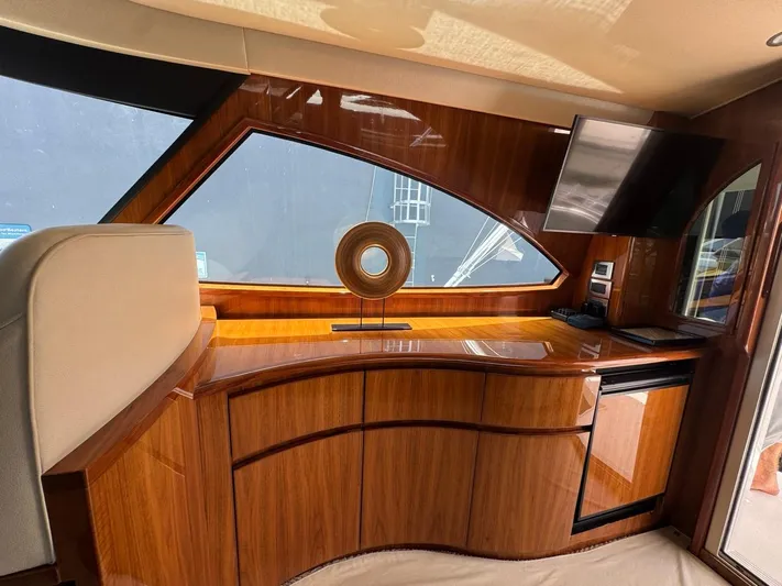 Dry Bones Yacht Photos Pics Luxurious interior of 2017 Viking 66 Enclosed Bridge yacht with sleek wood finish and modern amenities.