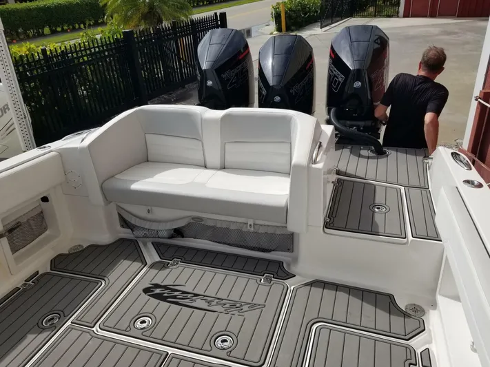 Power Slave Yacht Photos Pics 2020 Nor-Tech Center Console boat with triple outboard engines and cushioned seating.