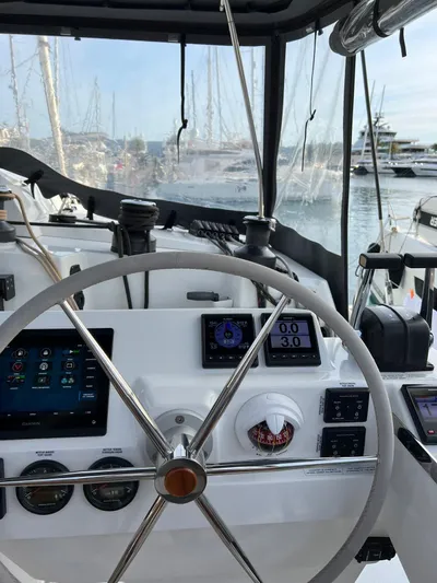  Yacht Photos Pics Helm of 2021 Fountaine Pajot Catamaran Elba 45 with navigation instruments and steering wheel.