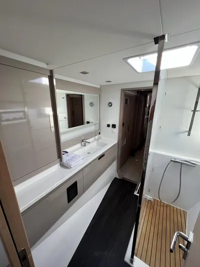  Yacht Photos Pics Modern bathroom in 2021 Fountaine Pajot Catamaran Elba 45 with sleek design and skylight.