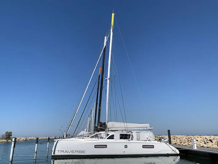 Traverse Yacht Photos Pics 2021 Outremer 51 catamaran docked in a marina under clear blue skies.