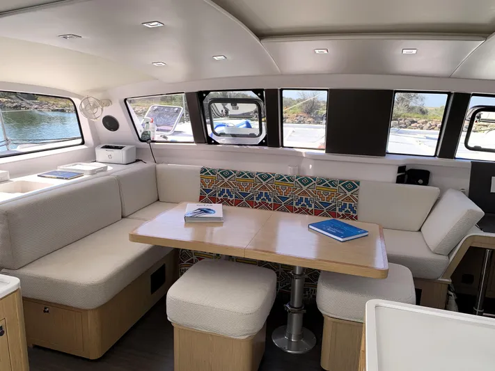 Traverse Yacht Photos Pics Luxurious interior of 2021 Outremer 51 catamaran with modern seating and large windows.