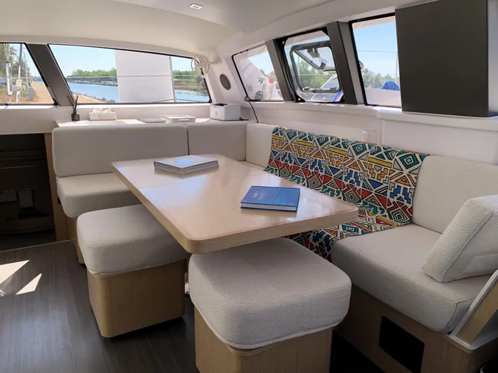 Traverse Yacht Photos Pics Luxurious interior of 2021 Outremer 51 catamaran with modern seating and vibrant cushions.