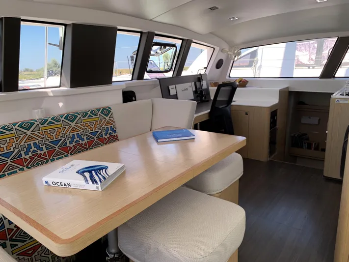 Traverse Yacht Photos Pics Interior of 2021 Outremer 51 yacht with modern dining area and colorful seating.