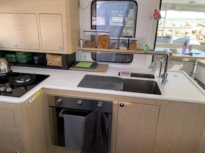 Traverse Yacht Photos Pics Modern kitchen in 2021 Outremer 51 yacht with stove, sink, and storage.