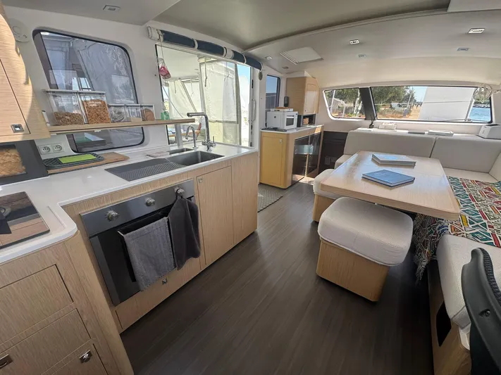 Traverse Yacht Photos Pics Modern interior of 2021 Outremer 51 catamaran with kitchen and dining area.