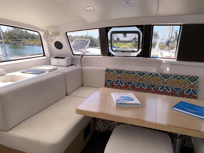 Traverse Yacht Photos Pics Interior of 2021 Outremer 51 catamaran with cozy seating and colorful decor.