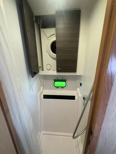 Traverse Yacht Photos Pics Compact bathroom with shower and washing machine in 2021 Outremer 51 yacht.