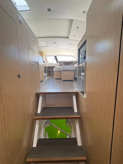 Traverse Yacht Photos Pics Interior view of 2021 Outremer 51 yacht, featuring wooden stairs and modern design.