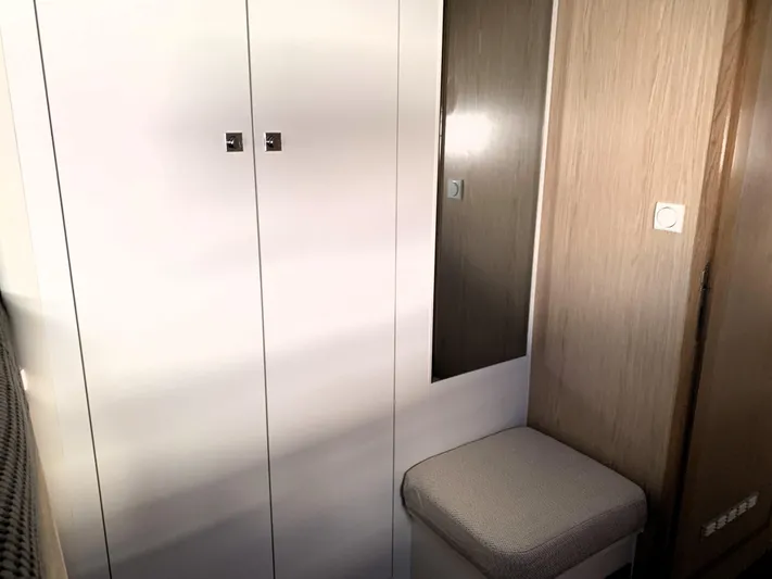 Traverse Yacht Photos Pics Interior of 2021 Outremer 51 yacht with white cabinets and cushioned seat.