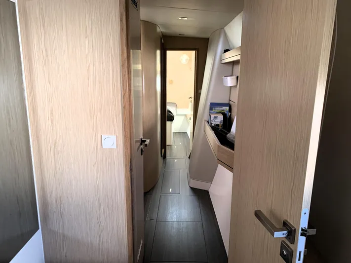 Traverse Yacht Photos Pics Interior hallway of a 2021 Outremer 51 yacht, featuring modern wood paneling and sleek design.