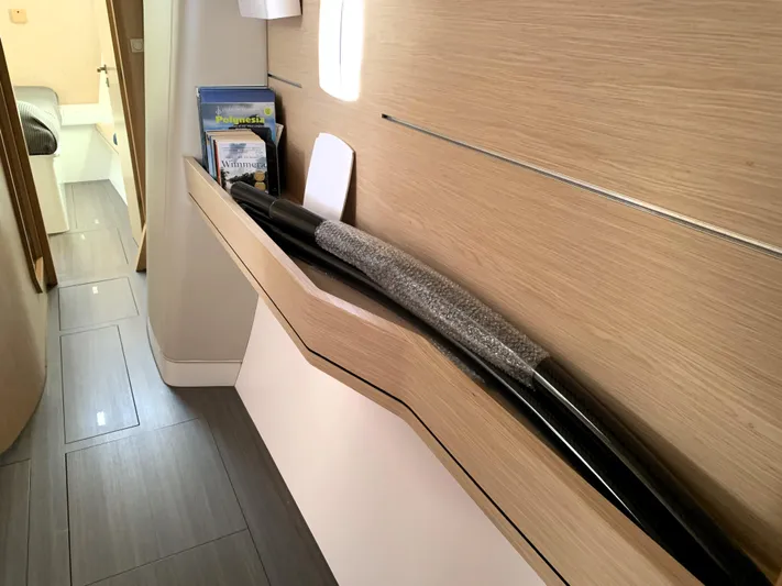 Traverse Yacht Photos Pics Interior of 2021 Outremer 51 yacht with sleek wooden paneling and storage shelves.