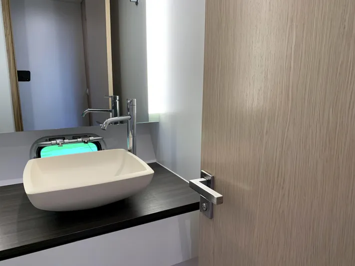 Traverse Yacht Photos Pics Modern bathroom interior of 2021 Outremer 51 yacht with sleek sink and faucet.