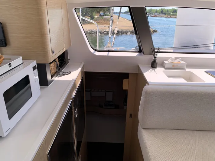 Traverse Yacht Photos Pics Modern interior of 2021 Outremer 51 yacht with kitchen and scenic window view.