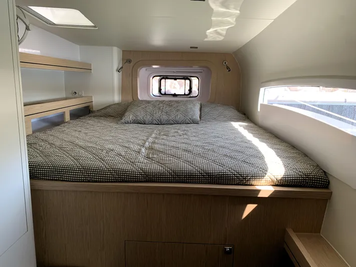 Traverse Yacht Photos Pics Cozy cabin interior of 2021 Outremer 51 yacht with bed and window.