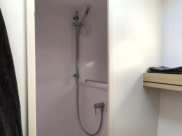 Traverse Yacht Photos Pics Modern shower area in 2021 Outremer 51 yacht, featuring sleek fixtures and minimalist design.