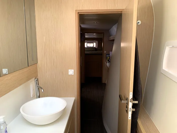 Traverse Yacht Photos Pics Modern bathroom interior on a 2021 Outremer 51 yacht, featuring sleek design and wooden finishes.