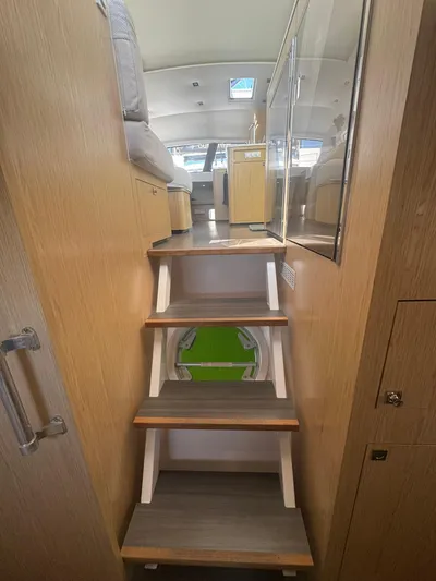 Traverse Yacht Photos Pics Interior view of 2021 Outremer 51 yacht, featuring wooden stairs and modern design.