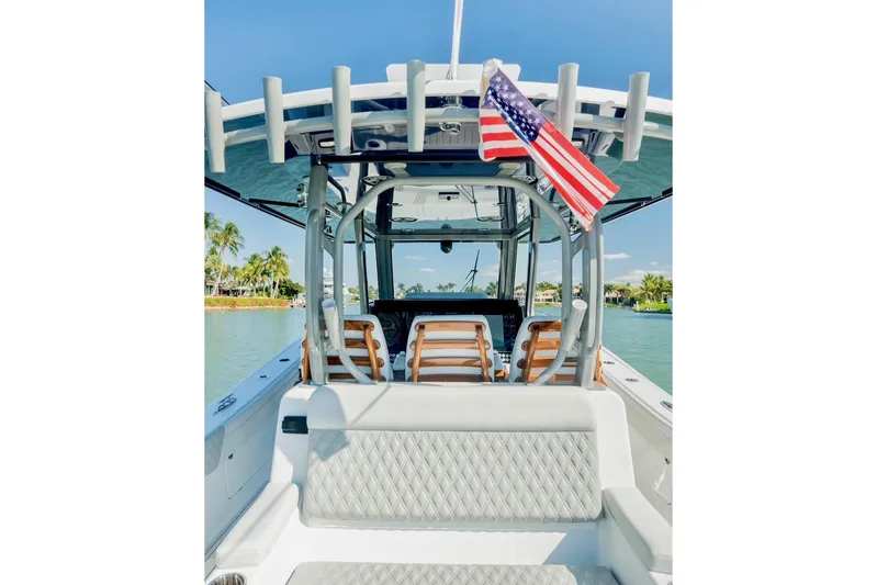  Yacht Photos Pics 2025 Costa Custom Boats 34 with American flag, docked in tropical waters.