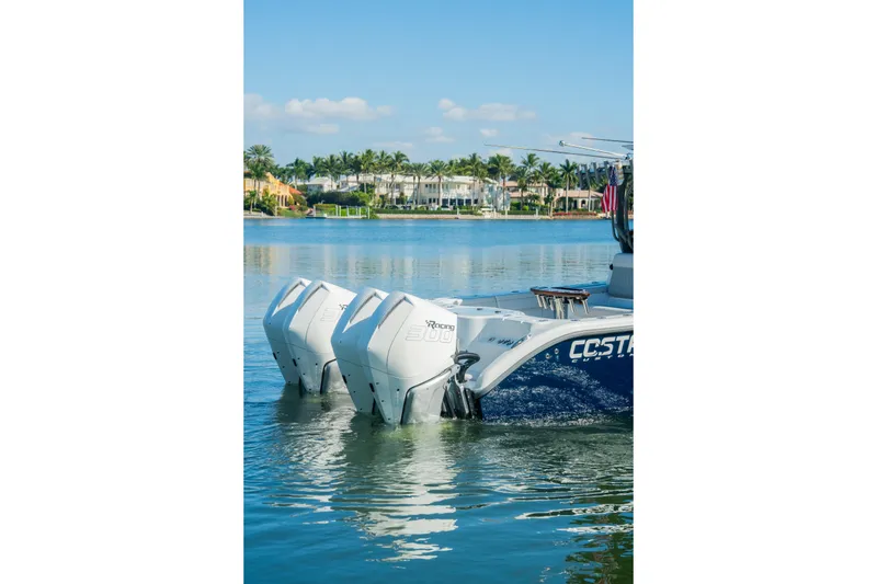  Yacht Photos Pics 2025 Costa Custom Boats 34 with twin engines on a serene waterway.