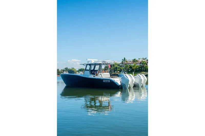  Yacht Photos Pics 2025 Costa Custom Boats 34 on calm water, featuring multiple outboard engines.