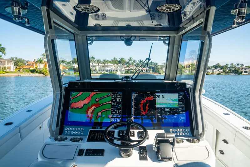  Yacht Photos Pics 2025 Costa Custom Boats 34 cockpit with advanced navigation displays on a serene waterway.