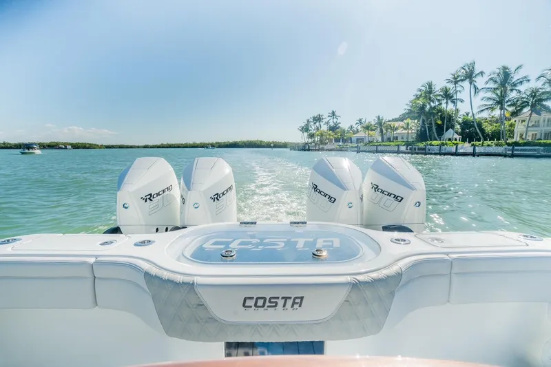  Yacht Photos Pics 2025 Costa Custom Boats 34 with triple engines cruising on a sunny day.