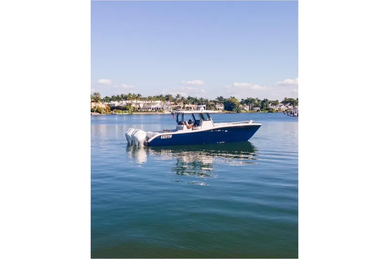  Yacht Photos Pics 2025 Costa Custom Boats 34 on calm water, showcasing sleek design and powerful engines.