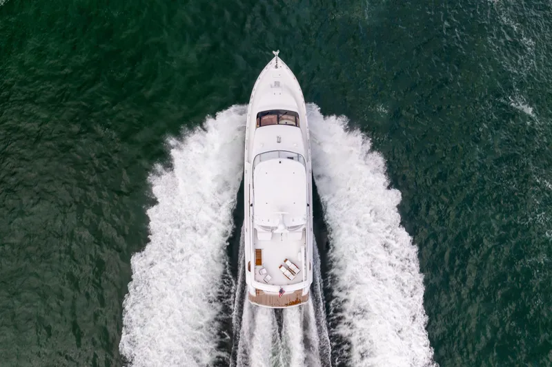 Outrageous Yacht Photos Pics Aerial view of 2005 Hatteras 80 Motor Yacht cruising on open water.