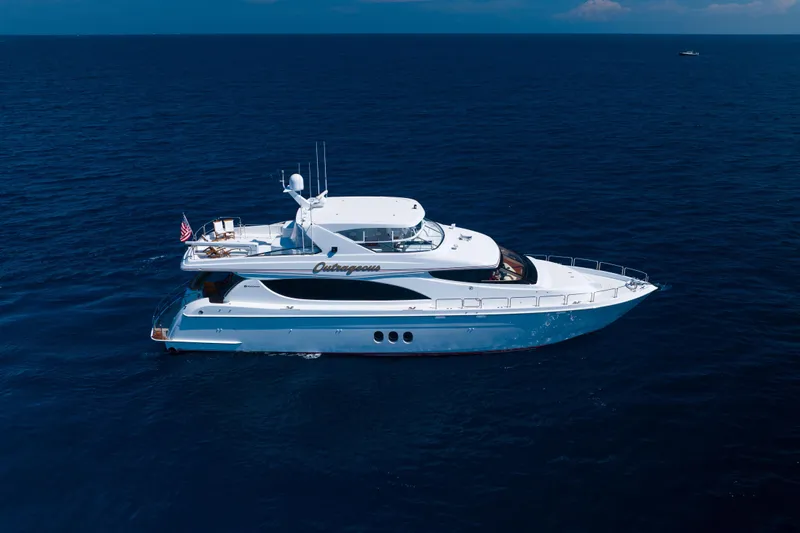 Outrageous Yacht Photos Pics 2005 Hatteras 80 Motor Yacht cruising on open ocean waters.