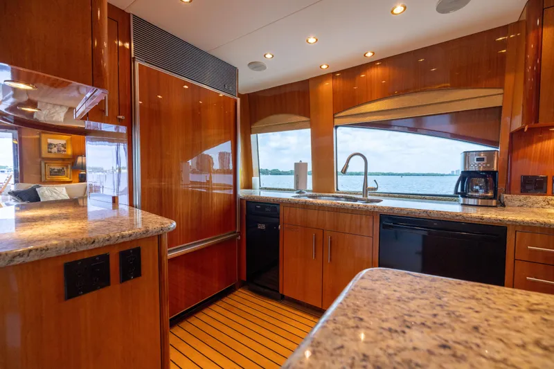 Outrageous Yacht Photos Pics Luxurious kitchen interior of 2005 Hatteras 80 Motor Yacht with wood cabinetry and ocean view.