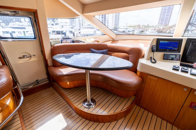 Outrageous Yacht Photos Pics Luxurious interior of 2005 Hatteras 80 Motor Yacht with leather seating and navigation equipment.