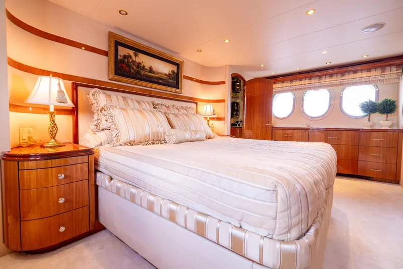 Outrageous Yacht Photos Pics Luxurious bedroom interior of 2005 Hatteras 80 Motor Yacht with elegant decor and porthole windows.