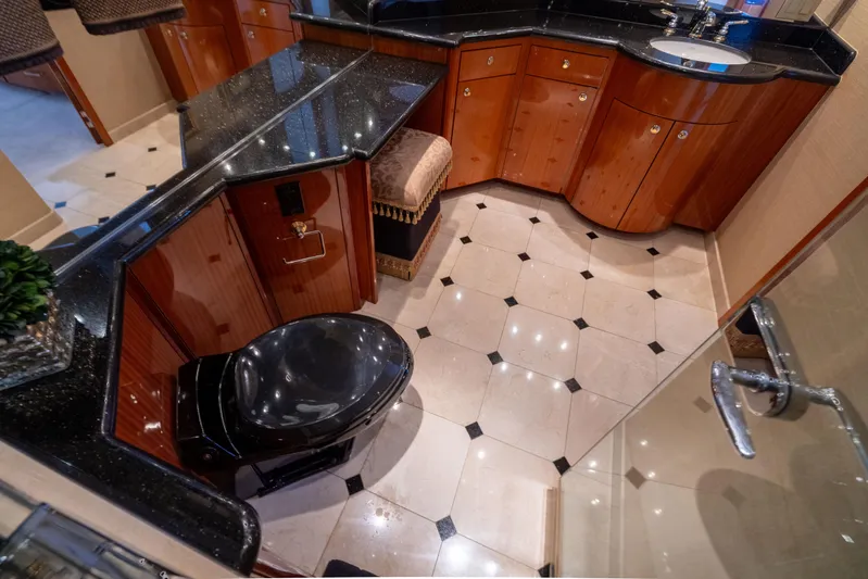 Outrageous Yacht Photos Pics Luxurious bathroom in 2005 Hatteras 80 Motor Yacht with elegant wood cabinetry and black fixtures.