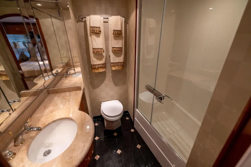 Outrageous Yacht Photos Pics Luxurious bathroom in 2005 Hatteras 80 Motor Yacht with elegant fixtures and marble countertop.