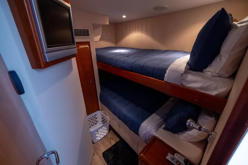 Outrageous Yacht Photos Pics Bunk beds in 2005 Hatteras 80 Motor Yacht cabin with TV and laundry basket.