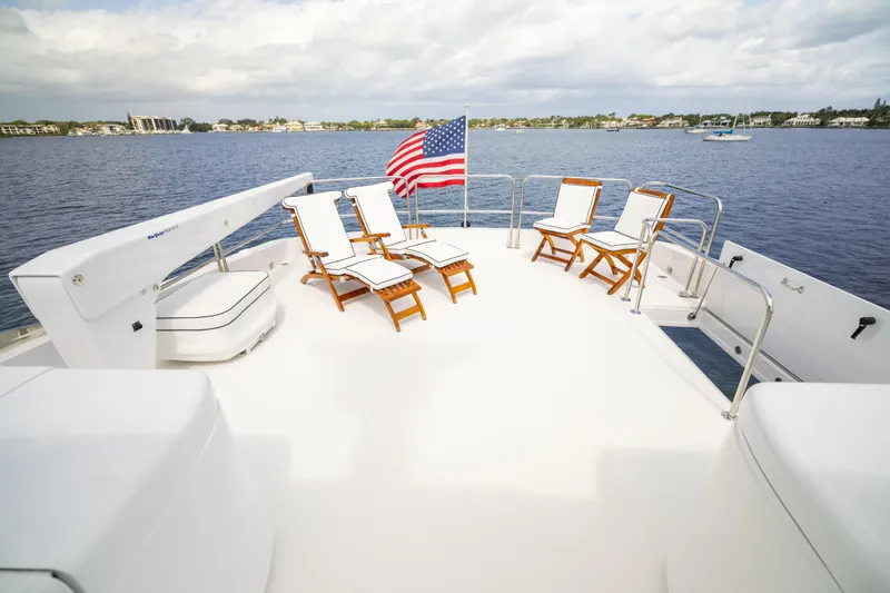 Outrageous Yacht Photos Pics Luxurious 2005 Hatteras 80 Motor Yacht deck with sun loungers and American flag.