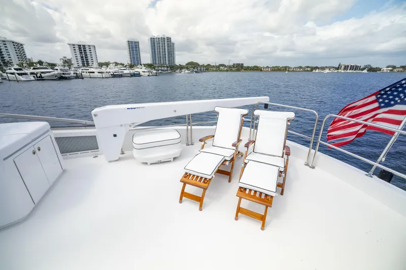 Outrageous Yacht Photos Pics Deck of 2005 Hatteras 80 Motor Yacht with lounge chairs and American flag.