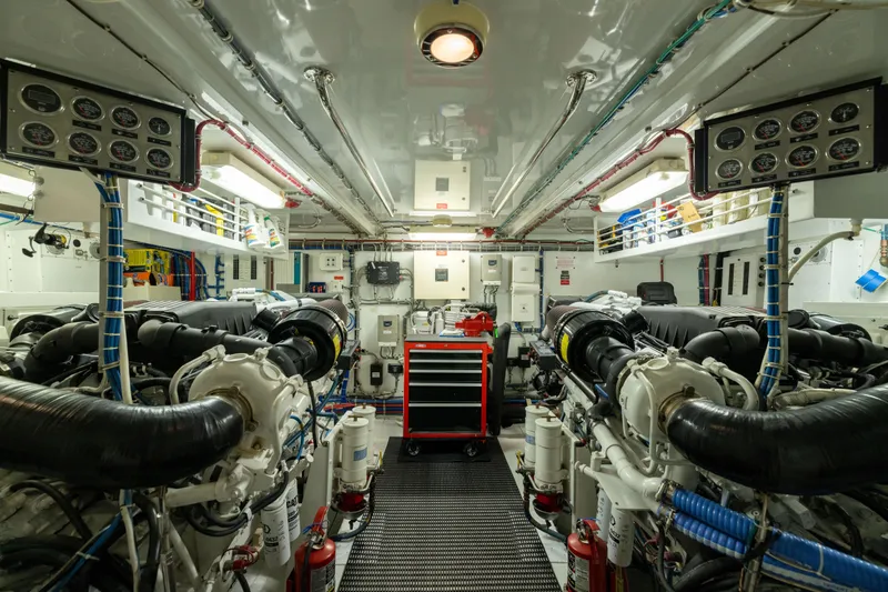 Outrageous Yacht Photos Pics Engine room of 2005 Hatteras 80 Motor Yacht, featuring dual engines and control panels.