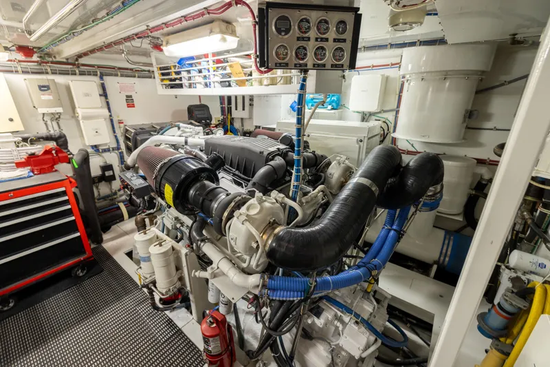 Outrageous Yacht Photos Pics Engine room of 2005 Hatteras 80 Motor Yacht, featuring complex machinery and control panel.