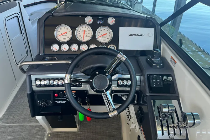 310 Bow Rider Yacht Photos Pics Dashboard of 2021 Formula 310 Bowrider I/O with steering wheel and Mercury controls.