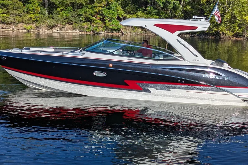 310 Bow Rider Yacht Photos Pics 2021 Formula 310 Bowrider I/O boat cruising on a calm lake with lush green shoreline.