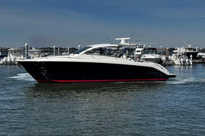 Sea Y'all III Yacht Photos Pics 2014 Pursuit SC 365i Sport Coupe cruising in a marina, surrounded by other boats.