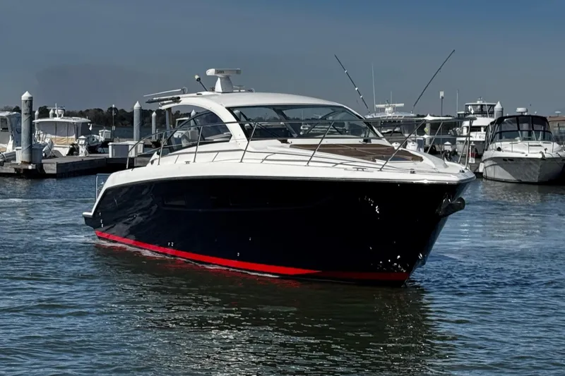 Sea Y'all III Yacht Photos Pics 2014 Pursuit SC 365i Sport Coupe yacht docked in marina, sleek design, blue hull.