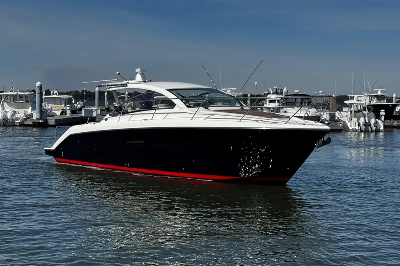 Sea Y'all III Yacht Photos Pics 2014 Pursuit SC 365i Sport Coupe yacht docked in a marina, sleek design, calm waters.
