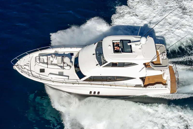 True North Yacht Photos Pics 2020 Maritimo M59 yacht cruising on open water, aerial view.